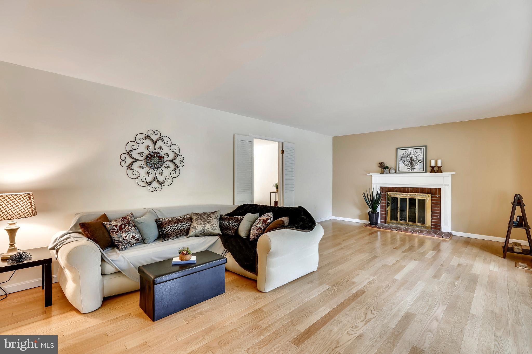 8902 Churchfield Lane Laurel, MD 20708 - Photo 2 of 30 Spacious living room with cozy fireplace