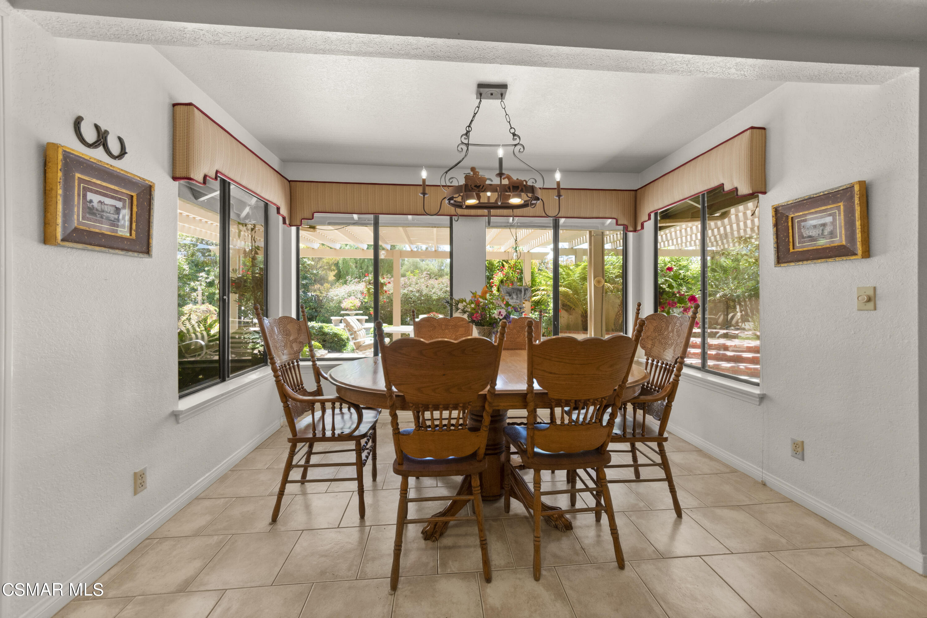 2774 Las Posas Circle Camarillo, CA 93012 - Photo 11 of 48 a view of a dining room with furniture large windows and wooden floor