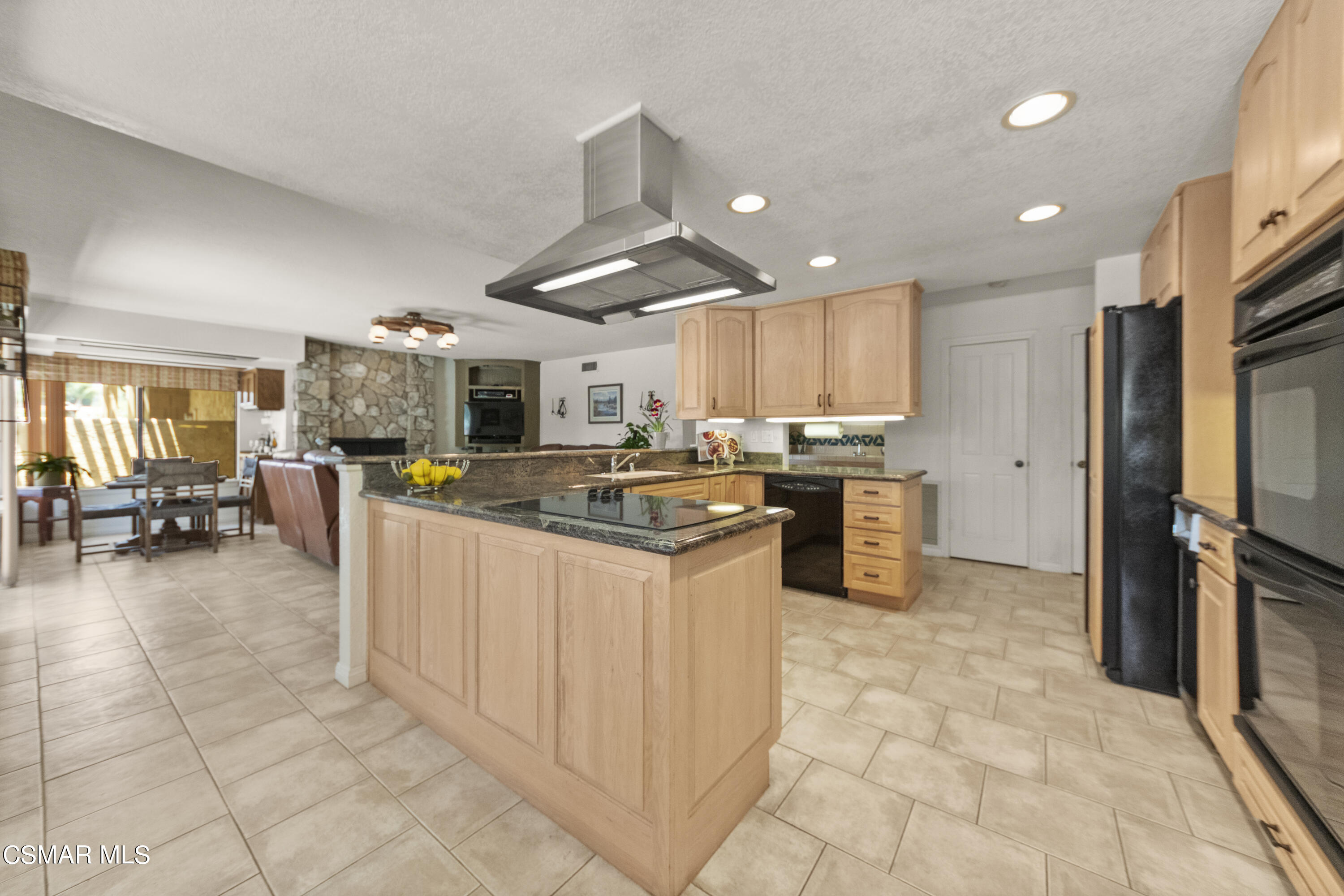 2774 Las Posas Circle Camarillo, CA 93012 - Photo 12 of 48 a kitchen with stainless steel appliances kitchen island granite countertop a stove refrigerator and cabinets