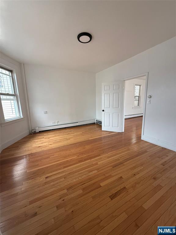 624 Madison Avenue Elizabeth, NJ 07201 - Photo 8 of 10 an empty room with wooden floor and windows