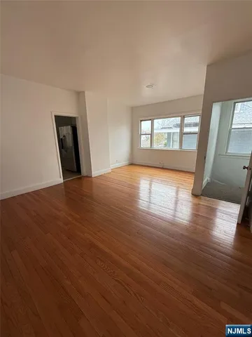 a view of a room with wooden floor and window