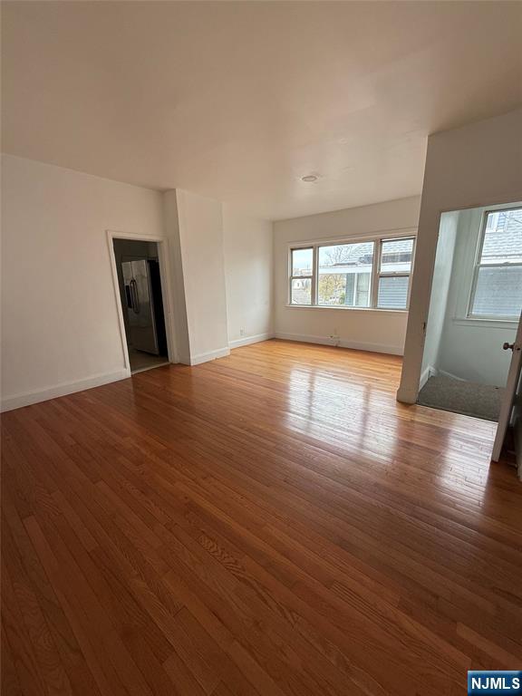 624 Madison Avenue Elizabeth, NJ 07201 - Photo 9 of 10 a view of empty room with wooden floor and fan