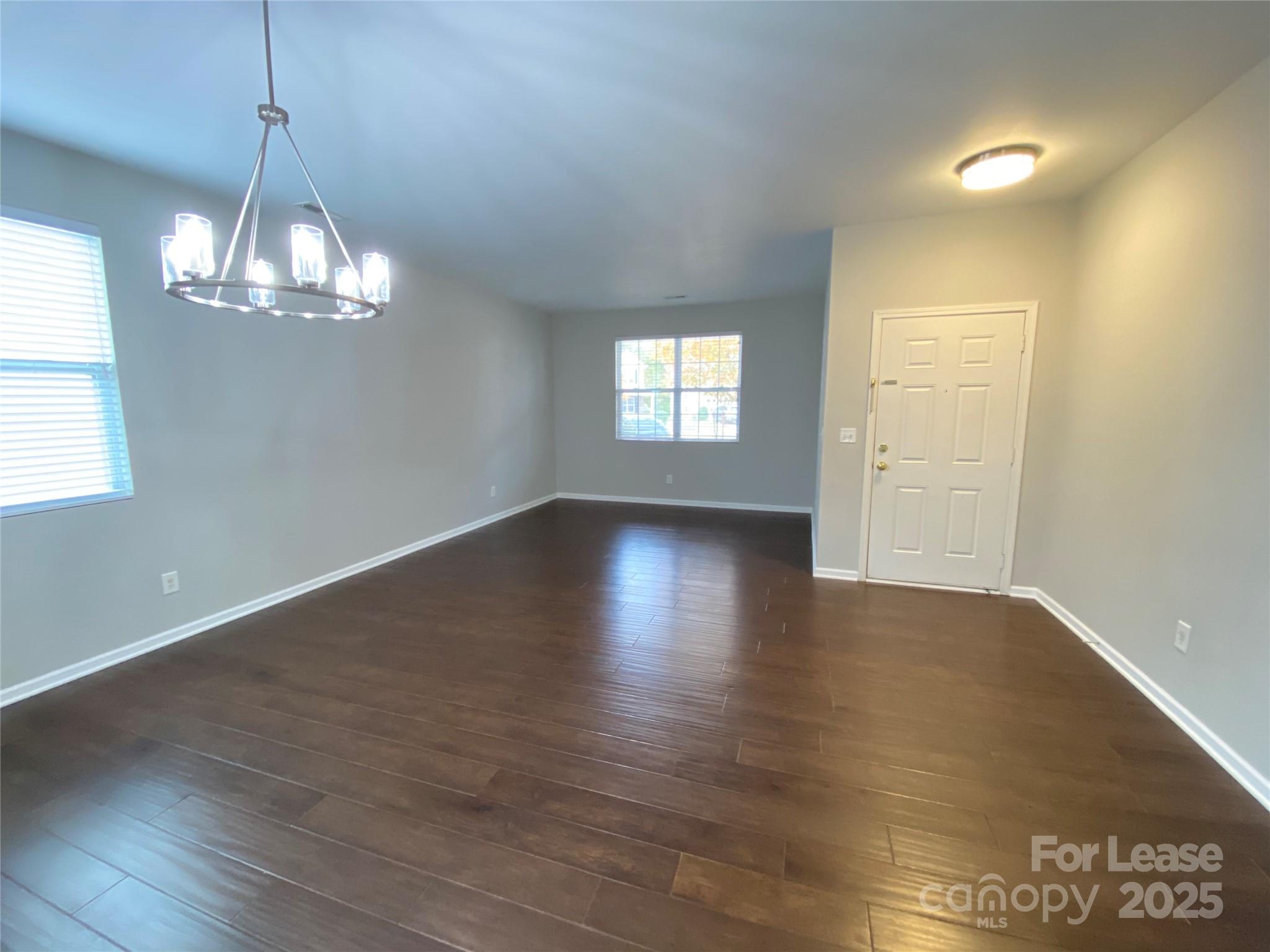 7306 Lamplighter Close Drive Matthews, NC 28105 - Photo 4 of 11 an empty room with wooden floor and windows