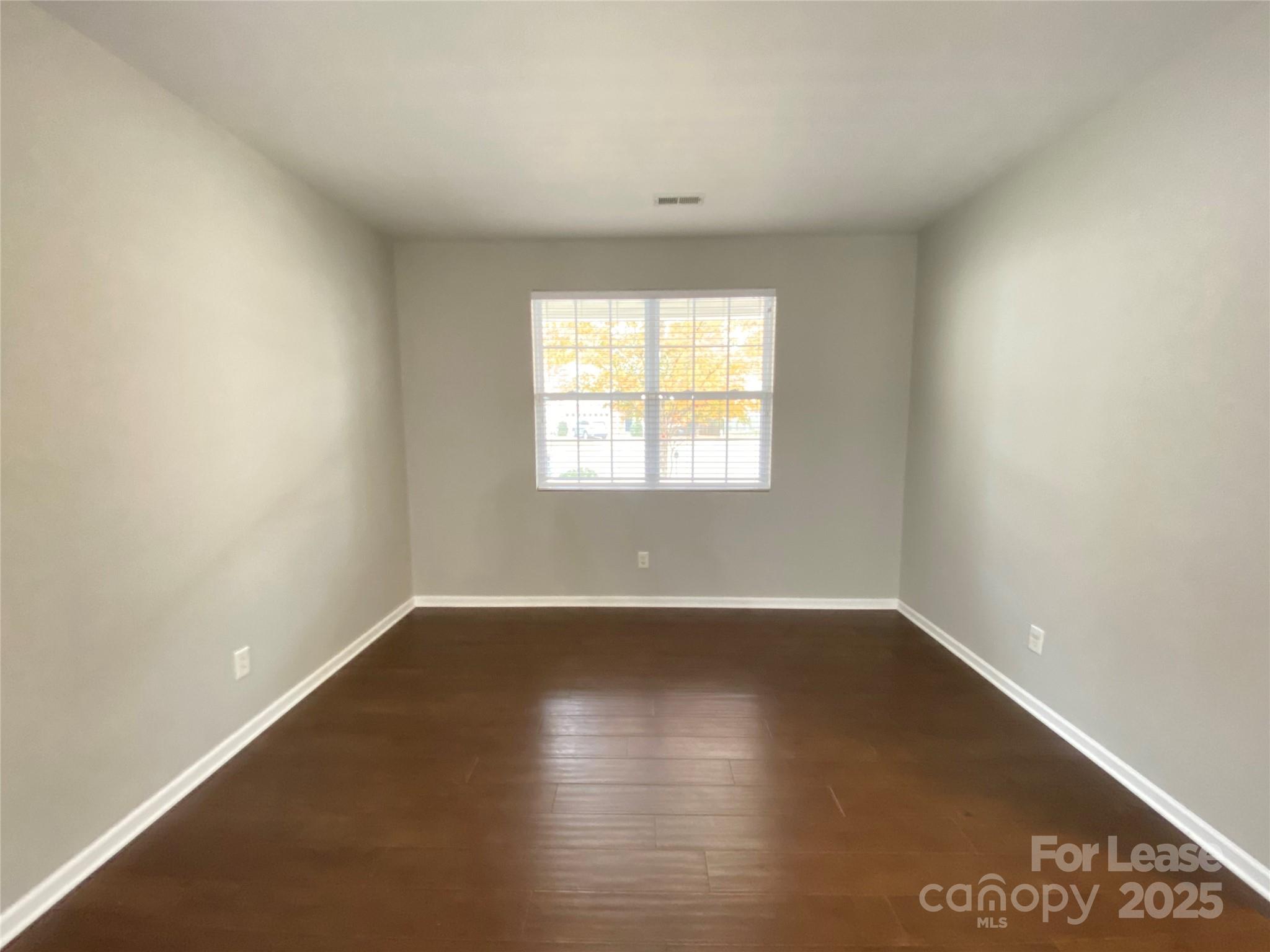 7306 Lamplighter Close Drive Matthews, NC 28105 - Photo 5 of 11 an empty room with wooden floor and windows