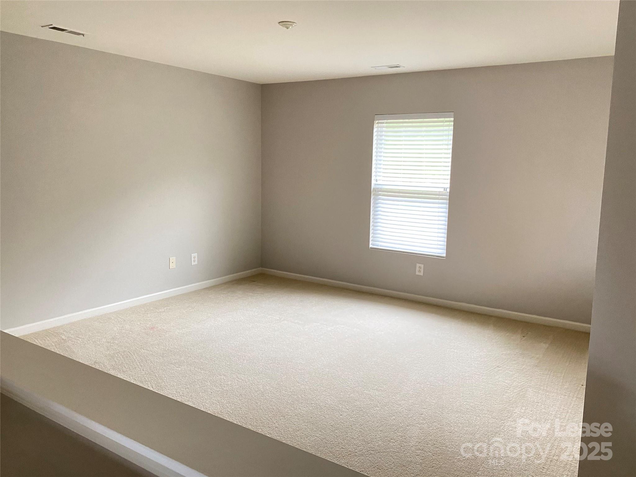 7306 Lamplighter Close Drive Matthews, NC 28105 - Photo 6 of 11 an empty room with a window