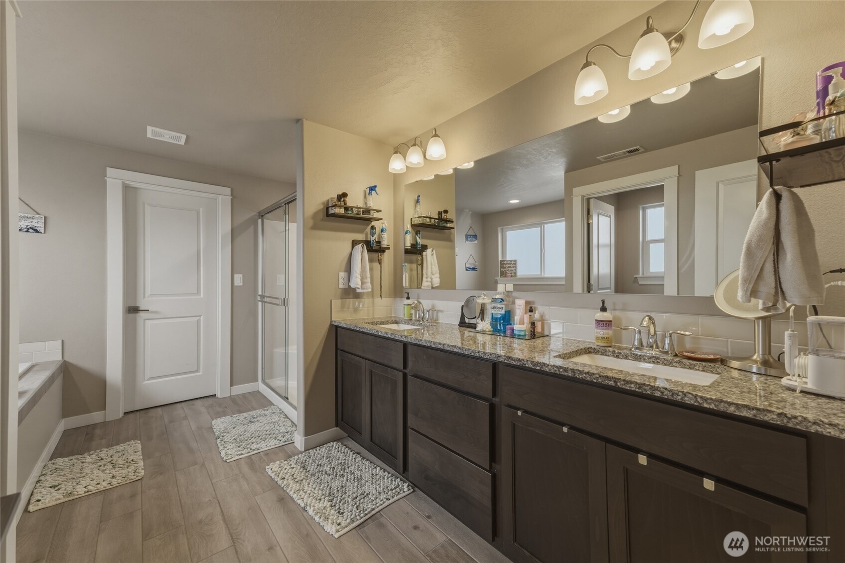 3070 Duval Loop Richland, WA 99352 - Photo 23 of 40 a spacious bathroom with a double vanity sink and a mirror