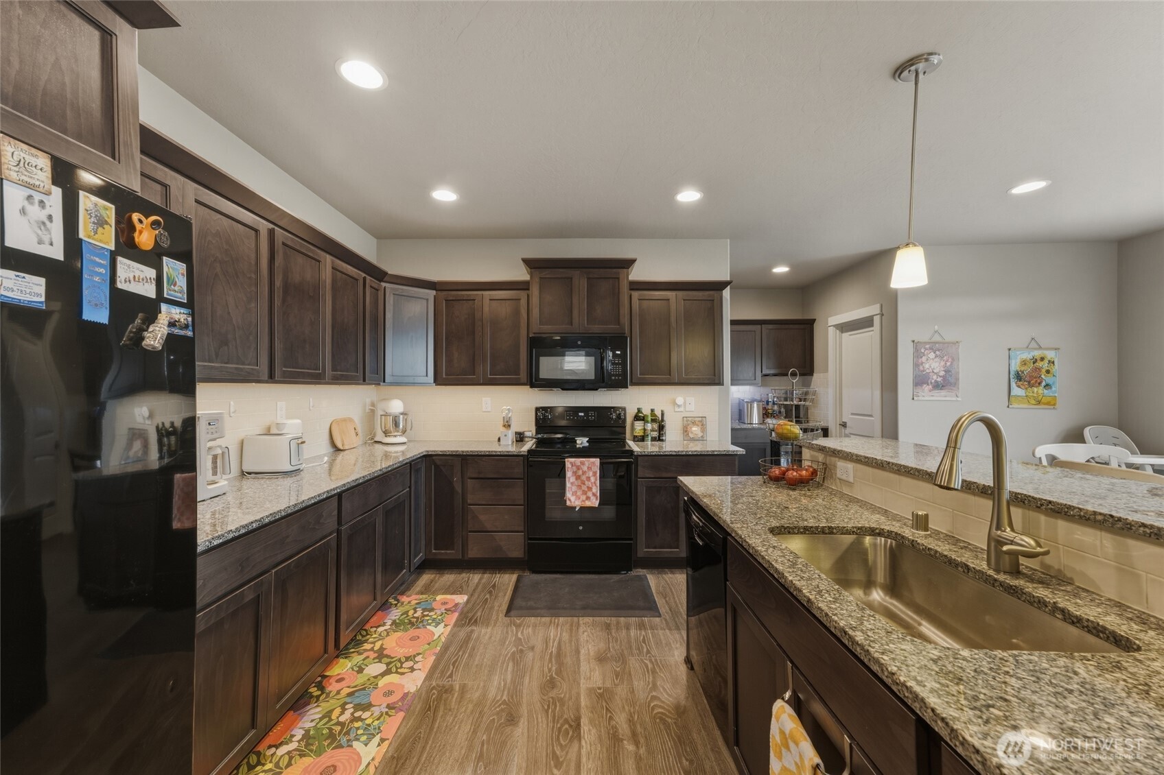 3070 Duval Loop Richland, WA 99352 - Photo 9 of 40 a kitchen with stainless steel appliances granite countertop a sink stove and refrigerator
