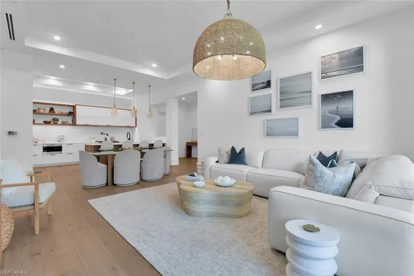 a living room with furniture and a chandelier