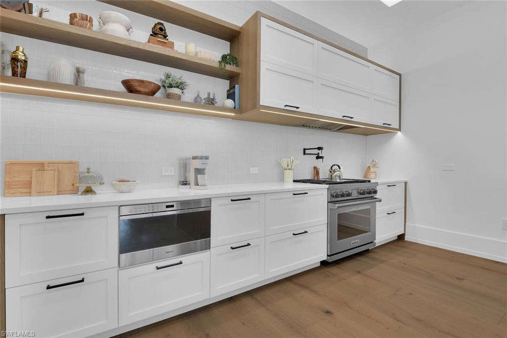 201 8th Street South, Unit 208 Naples, FL 34102 - Photo 13 of 46 a kitchen with stainless steel appliances granite countertop white cabinets a sink and dishwasher