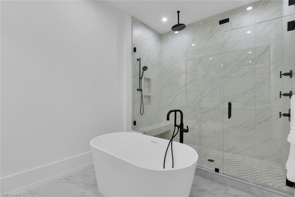 201 8th Street South, Unit 208 Naples, FL 34102 - Photo 18 of 46 a white bath tub sitting in a bathroom and shower