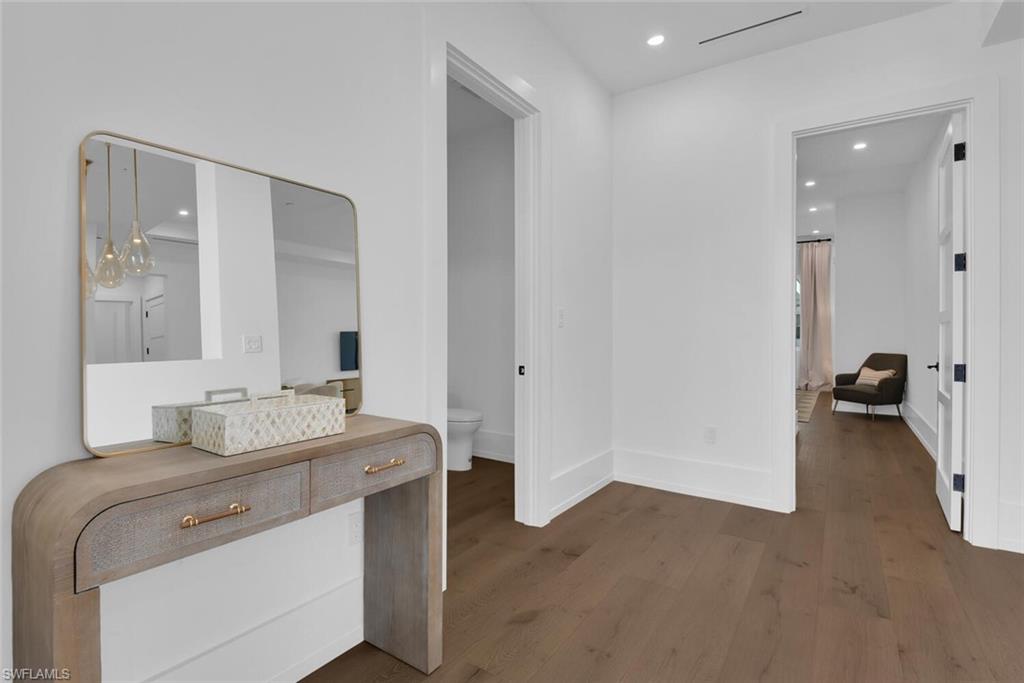 201 8th Street South, Unit 208 Naples, FL 34102 - Photo 2 of 46 a en suite bathroom with a granite countertop sink and a mirror
