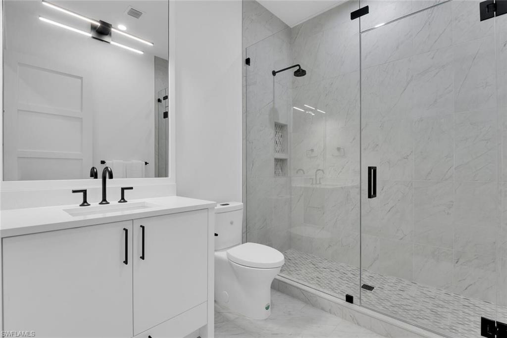 201 8th Street South, Unit 208 Naples, FL 34102 - Photo 22 of 46 a bathroom with a sink toilet and shower