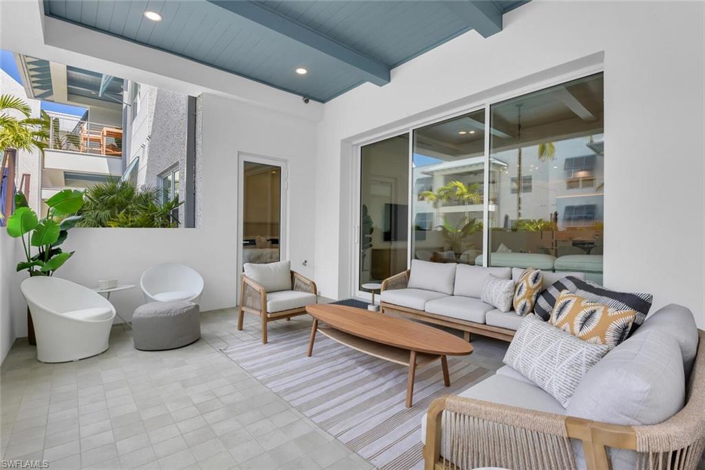 201 8th Street South, Unit 208 Naples, FL 34102 - Photo 23 of 46 a living room with furniture and a large window