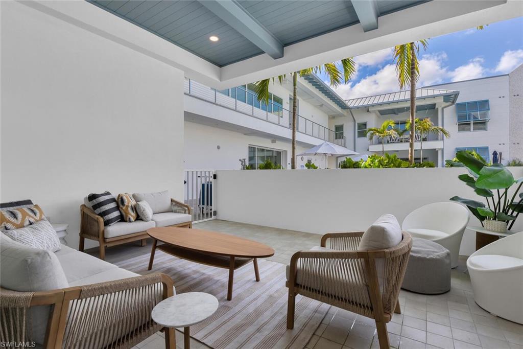 201 8th Street South, Unit 208 Naples, FL 34102 - Photo 25 of 46 a living room with furniture and a potted plant