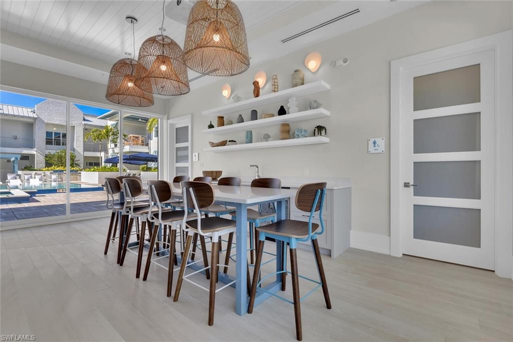 201 8th Street South, Unit 208 Naples, FL 34102 - Photo 37 of 46 a view of a dining room with furniture and chandelier