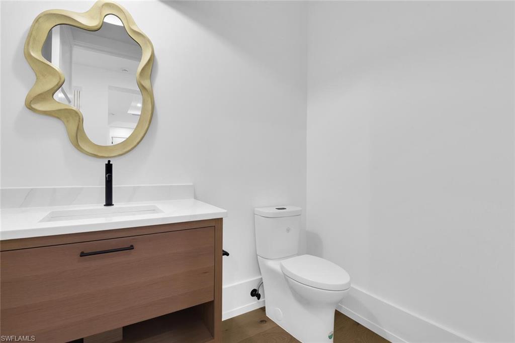 201 8th Street South, Unit 208 Naples, FL 34102 - Photo 4 of 46 a bathroom with a toilet and a mirror
