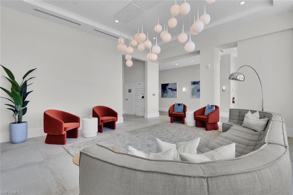 201 8th Street South, Unit 208 Naples, FL 34102 - Photo 40 of 46 a living room with furniture flowerpot and a chandelier
