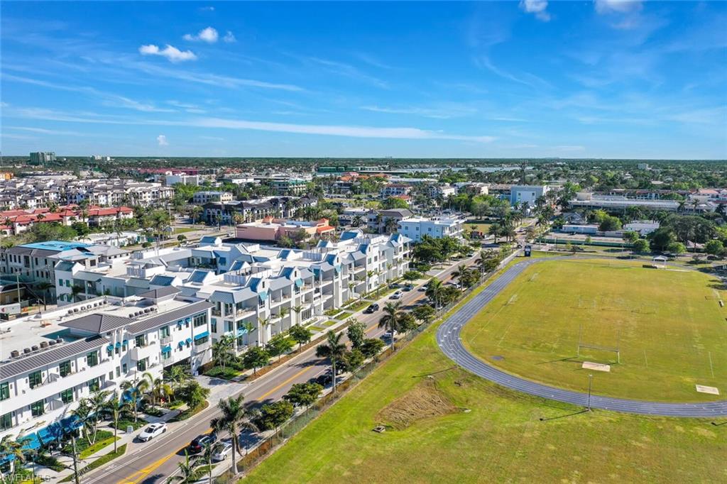 201 8th Street South, Unit 208 Naples, FL 34102 - Photo 43 of 46 an aerial view of residential building and lake