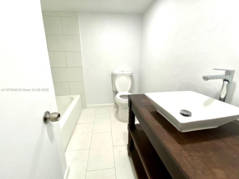 4307 Southwest 9th Street, Unit 4307 Miami, FL 33134 - Photo 6 of 12 a bathroom with a sink and a toilet
