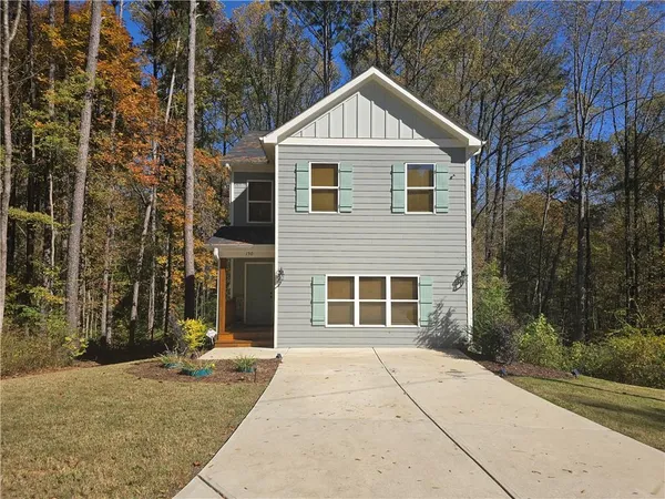 a front view of a house with a yard