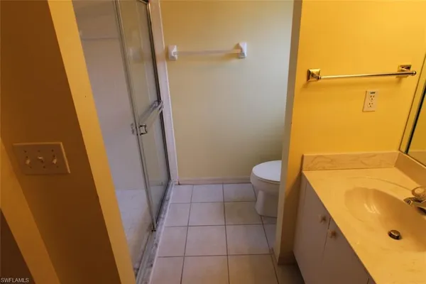 a bathroom with a sink a toilet a tub and shower