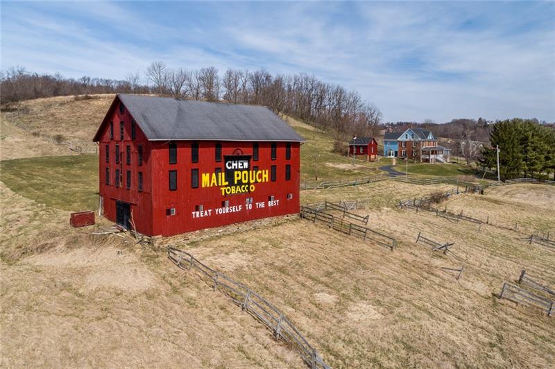 619 Pleasant Valley Road Washington, PA 15301 - Photo 22 of 25 Bank barn with Mail Pouch logo. View of springhouse and house.