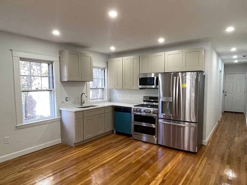 96 Walnut Street, Unit 2 Brookline, MA 02445 - Photo 1 of 13 a kitchen with granite countertop stainless steel appliances a refrigerator sink and microwave