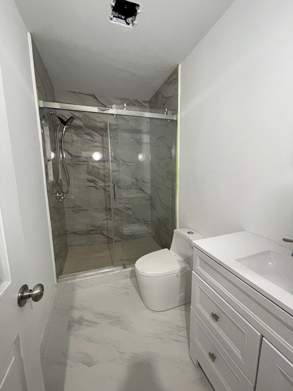 96 Walnut Street, Unit 2 Brookline, MA 02445 - Photo 12 of 13 a bathroom with a shower a toilet and a sink