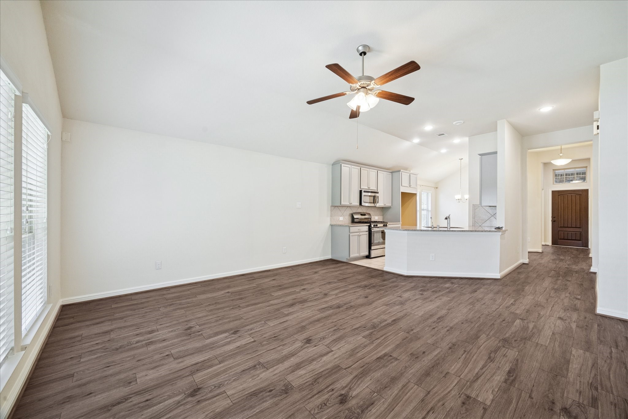 18203 Alora Springs Trace Cypress, TX 77433 - Photo 14 of 30 a view of a kitchen with wooden floor and a window