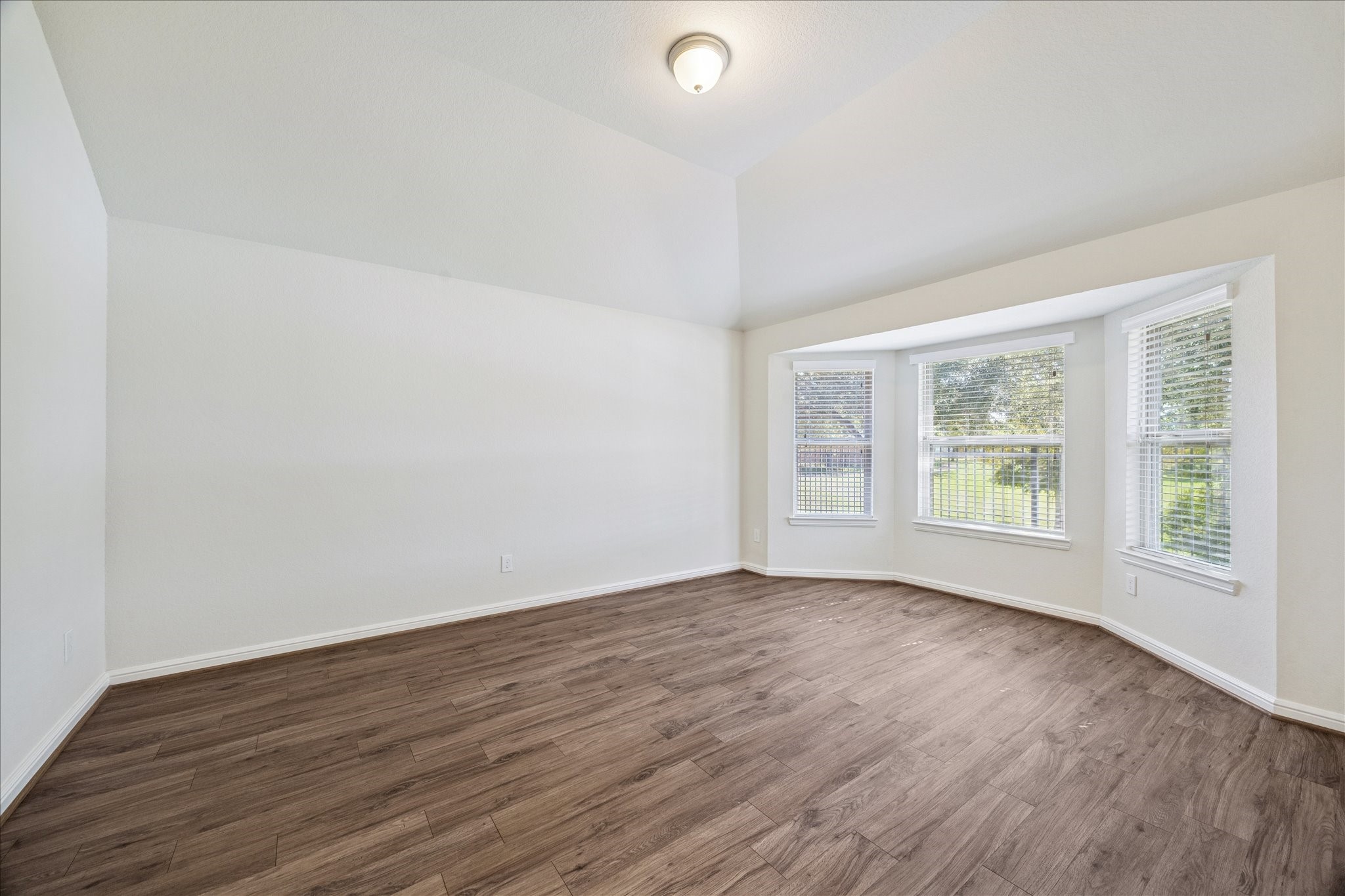 18203 Alora Springs Trace Cypress, TX 77433 - Photo 18 of 30 a view of an empty room with wooden floor and a window
