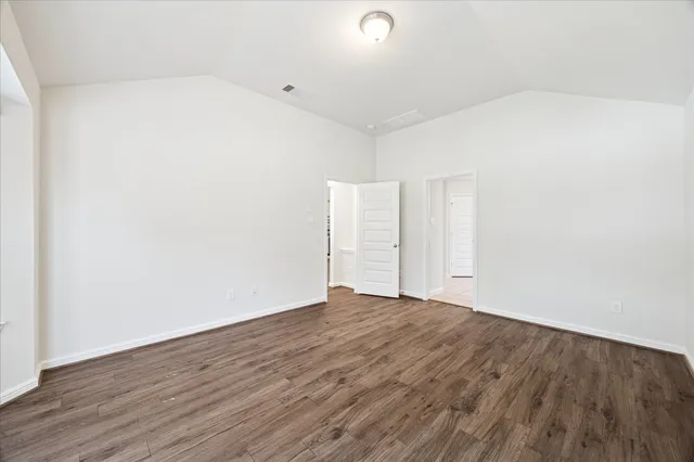 an empty room with wooden floor