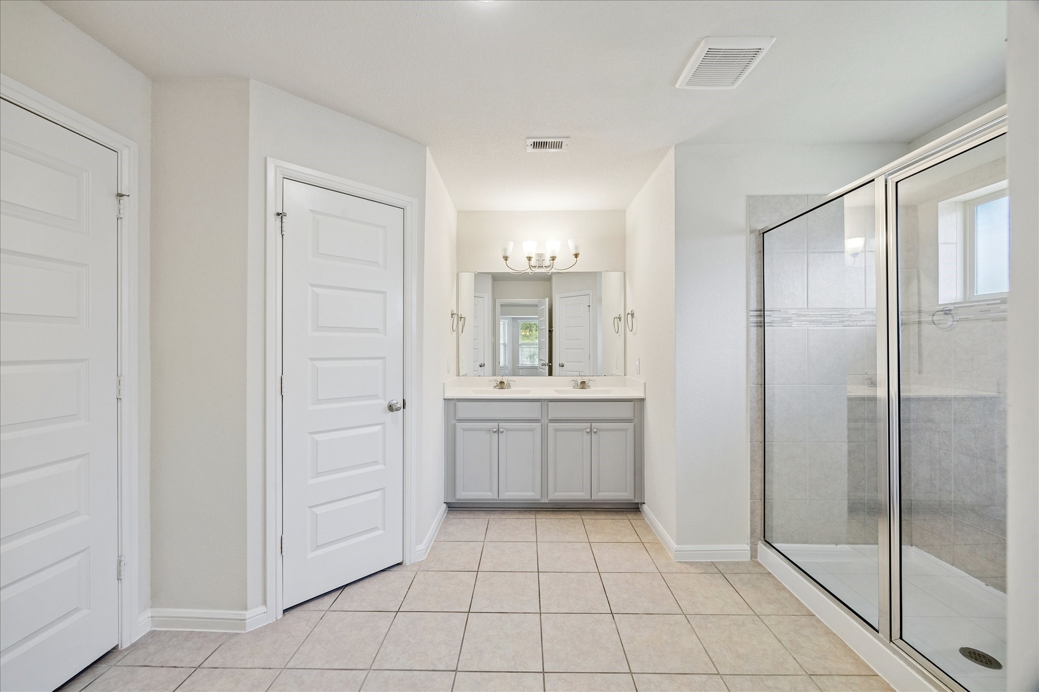 18203 Alora Springs Trace Cypress, TX 77433 - Photo 20 of 30 a bathroom with a shower a sink and a mirror
