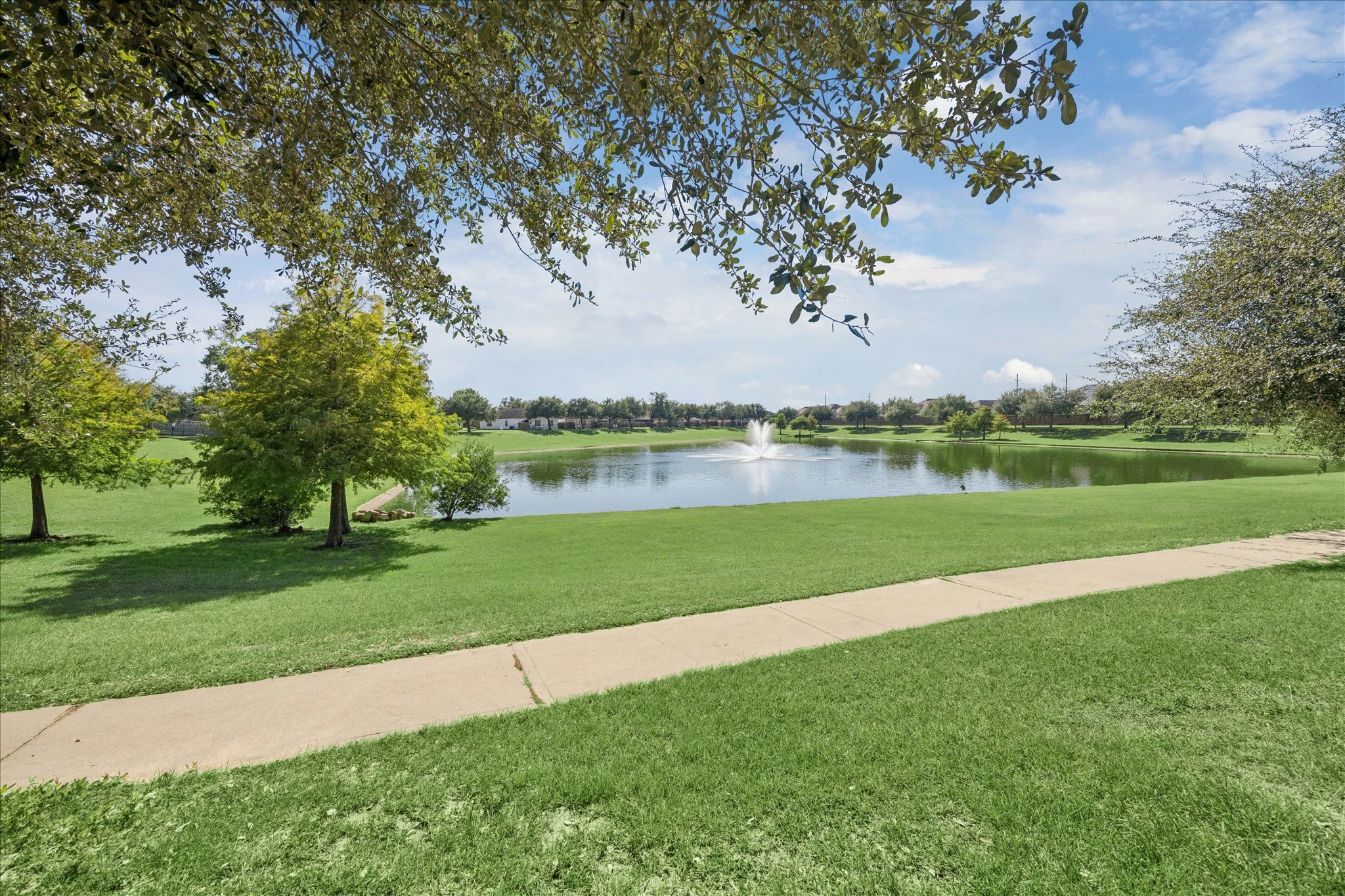 18203 Alora Springs Trace Cypress, TX 77433 - Photo 30 of 30 a view of a lake with a big yard and large trees