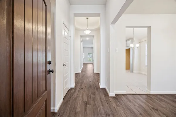 a view of a hallway with wooden floor