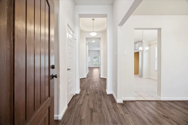 a view of a hallway with wooden floor