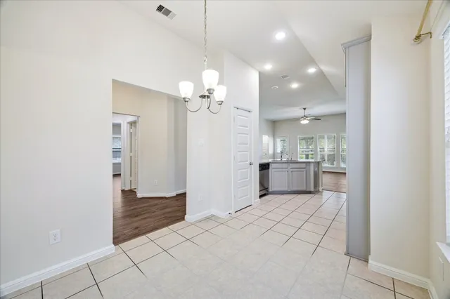 a view of a kitchen with a sink and a refrigerator