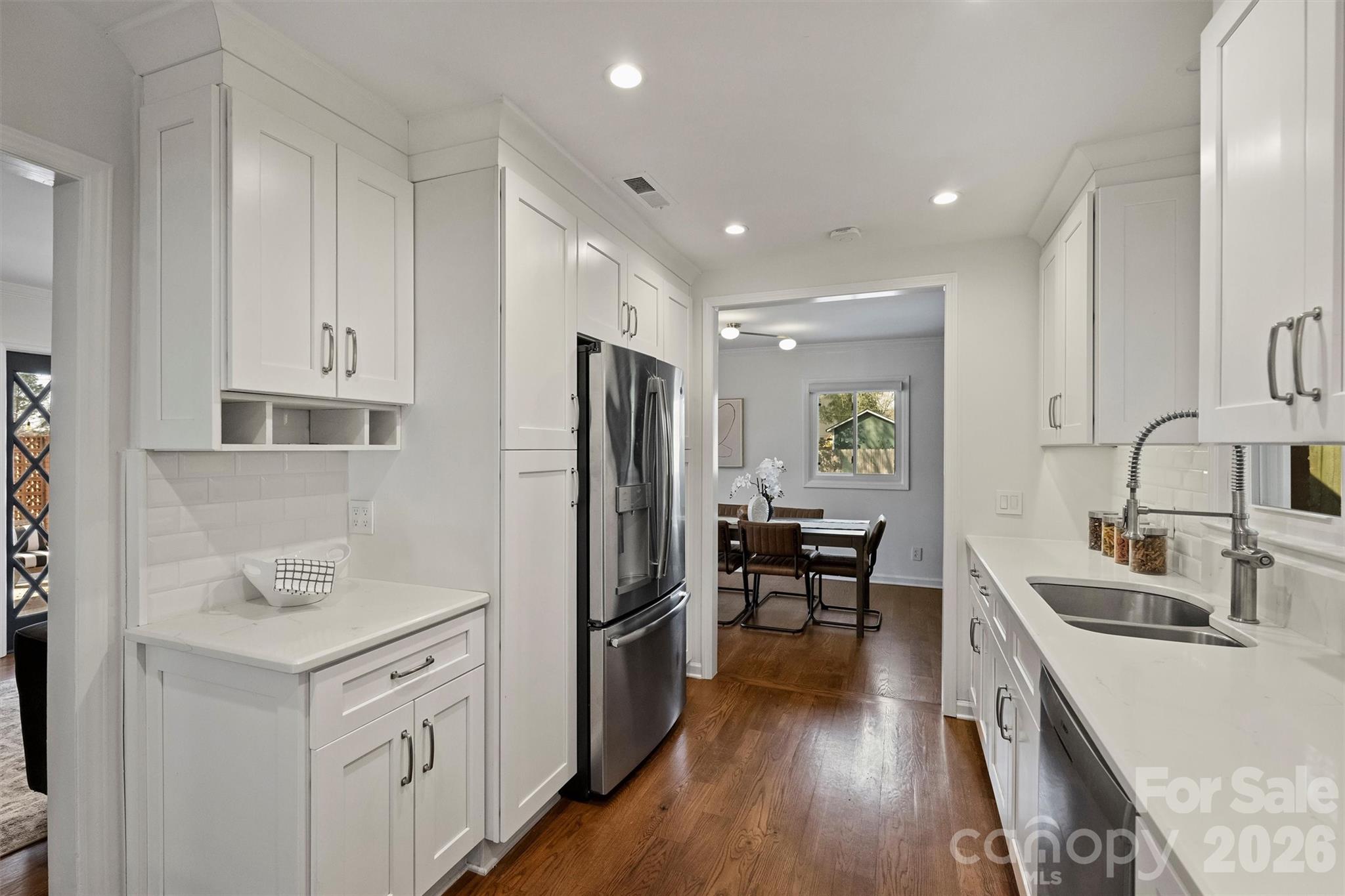 3808 Flowerfield Road Charlotte, NC 28210 - Photo 22 of 48 a kitchen with a refrigerator a sink and wooden cabinets
