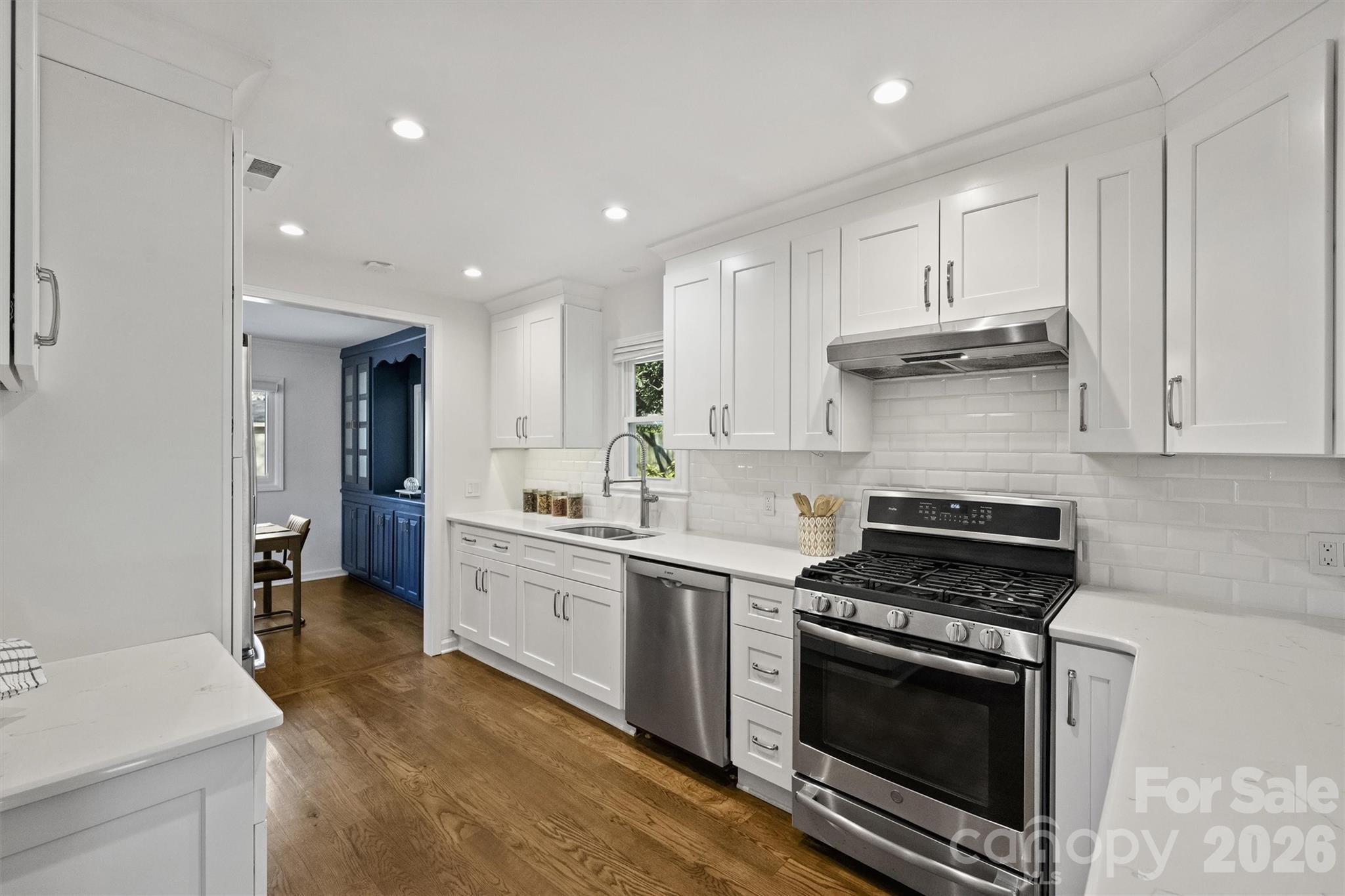 3808 Flowerfield Road Charlotte, NC 28210 - Photo 23 of 48 a kitchen with stainless steel appliances white cabinets and a stove top oven