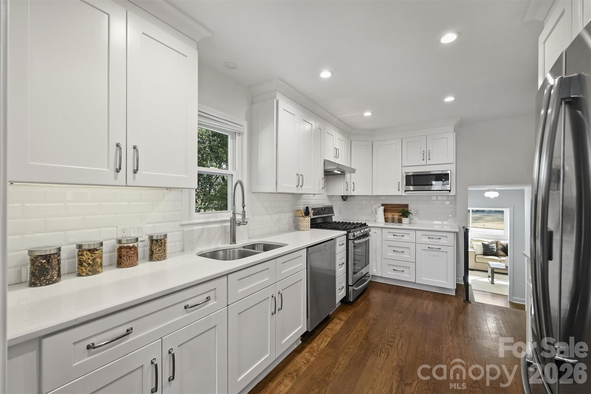 3808 Flowerfield Road Charlotte, NC 28210 - Photo 24 of 48 a kitchen with white cabinets and white appliances