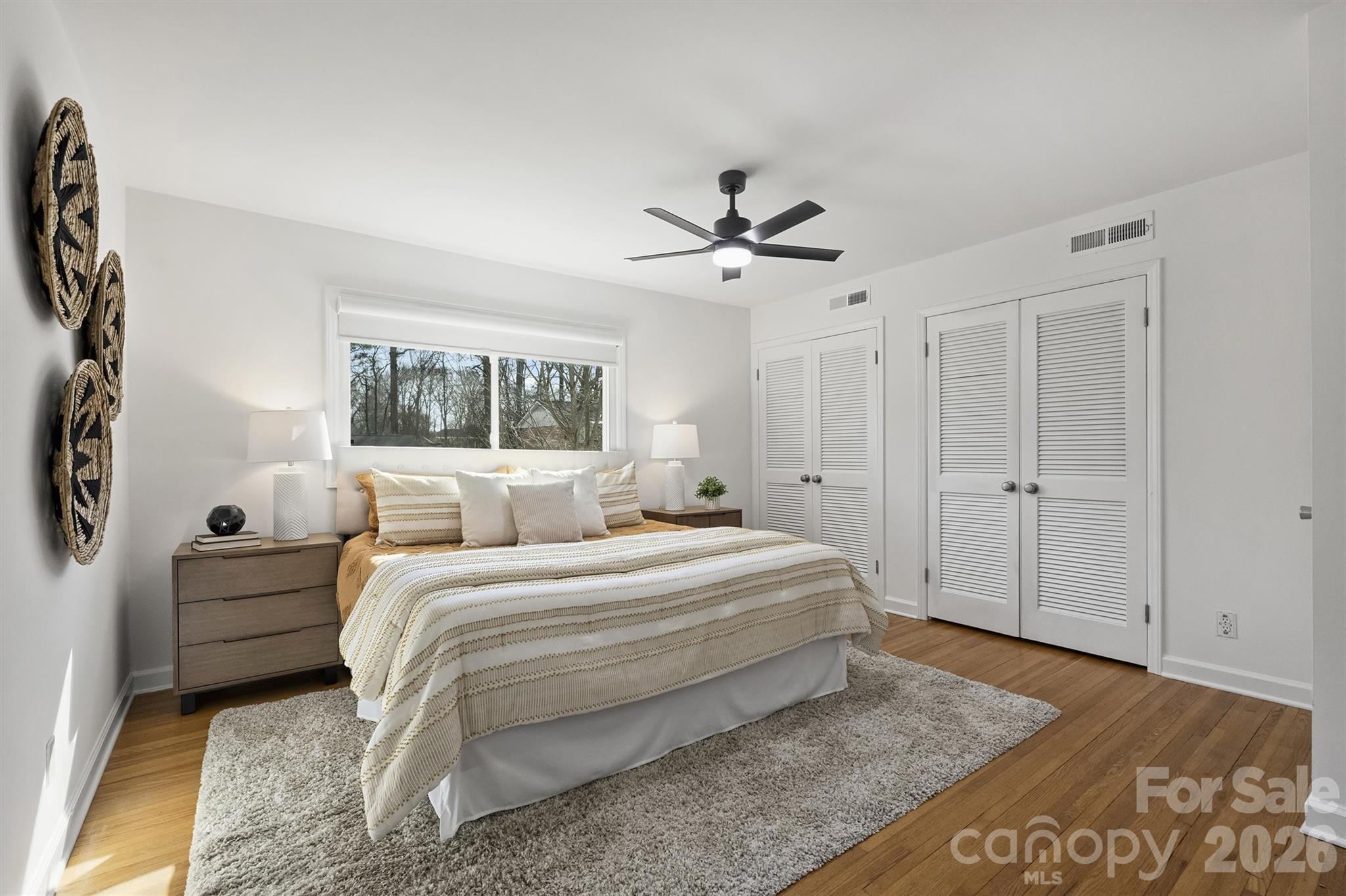 3808 Flowerfield Road Charlotte, NC 28210 - Photo 28 of 48 a spacious bedroom with a bed a window and a chandelier