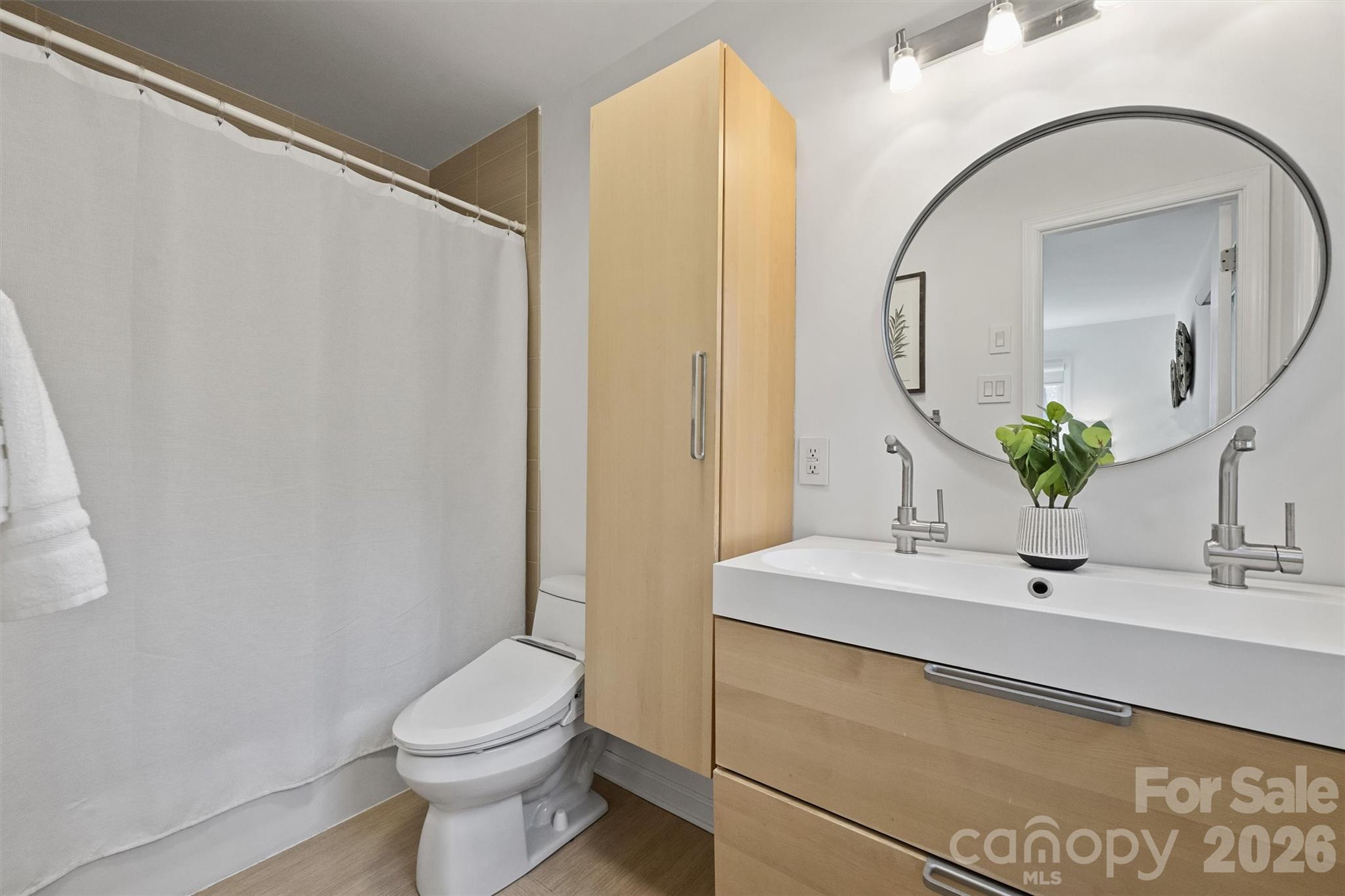 3808 Flowerfield Road Charlotte, NC 28210 - Photo 29 of 48 a bathroom with a sink a toilet and shower