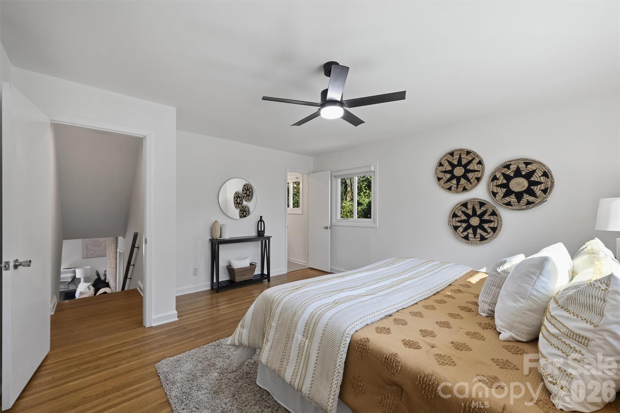 3808 Flowerfield Road Charlotte, NC 28210 - Photo 31 of 48 a bedroom with a bed and a chandelier