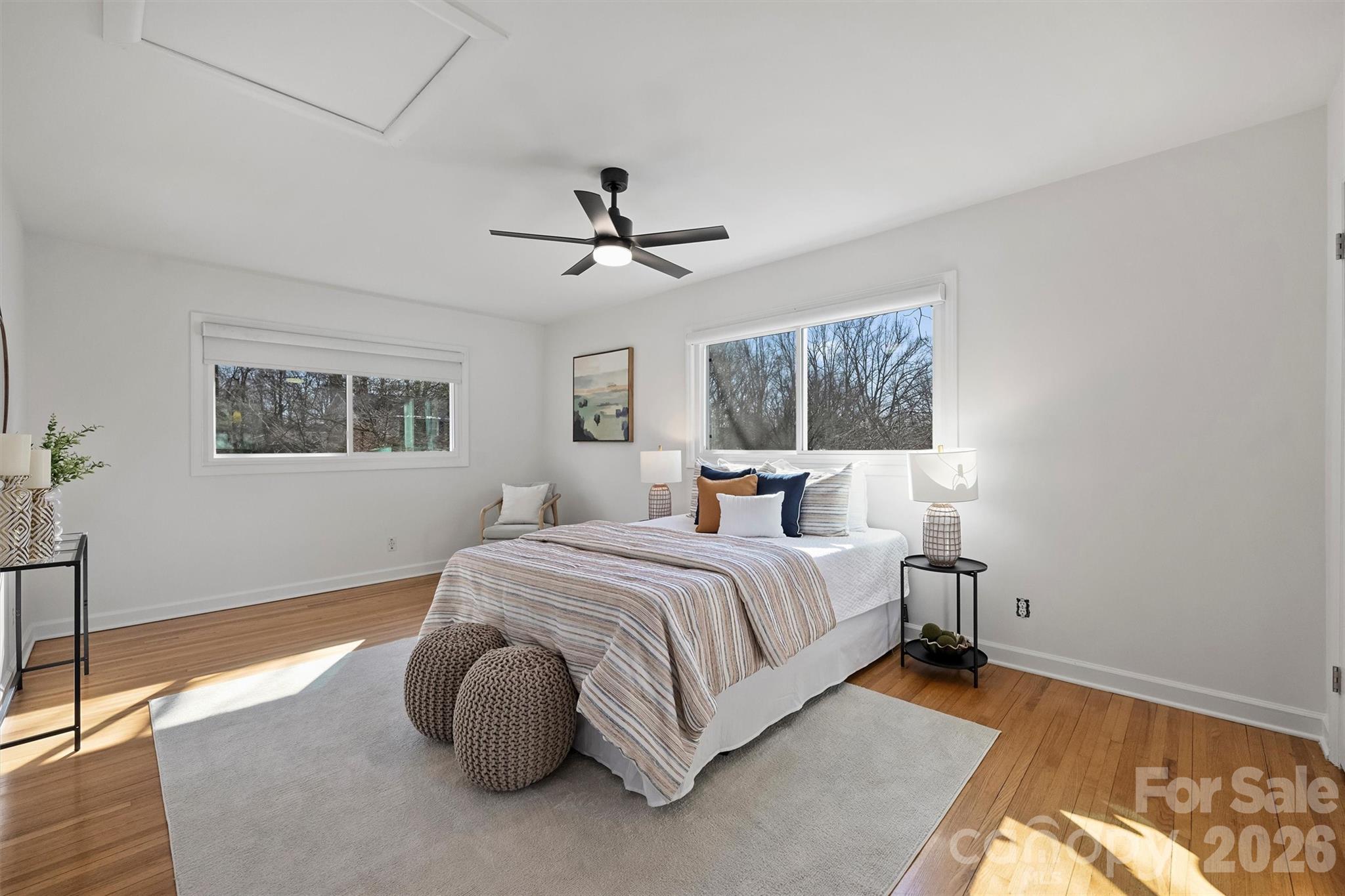 3808 Flowerfield Road Charlotte, NC 28210 - Photo 34 of 48 a bedroom with a large bed and a chandelier