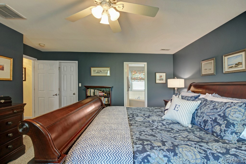 1431 Goswick Ridge Road Midlothian, VA 23114 - Photo 15 of 24 a bedroom with a large bed and a chandelier