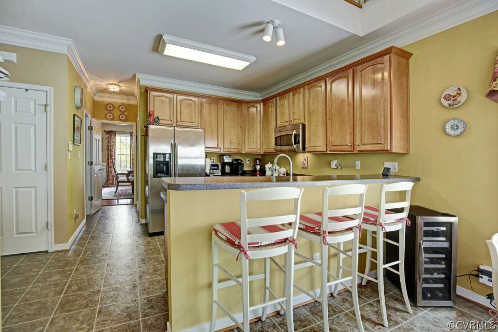 1431 Goswick Ridge Road Midlothian, VA 23114 - Photo 9 of 24 a kitchen with stainless steel appliances kitchen island granite countertop a table and chairs in it