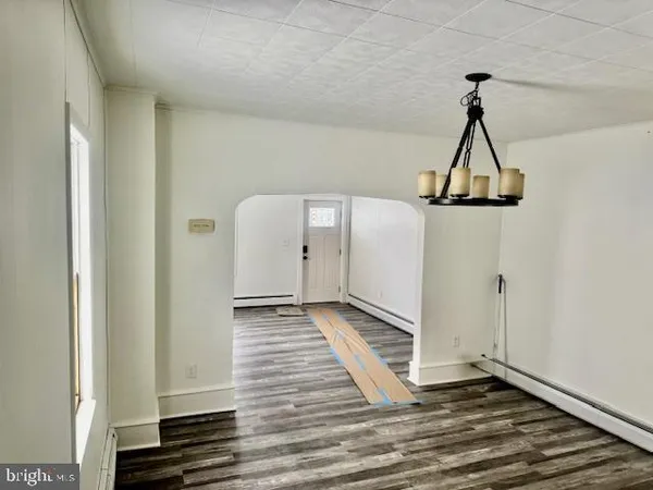 a view of a room with wooden floor