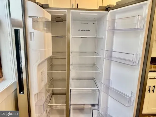 a view of walk in closet with empty racks