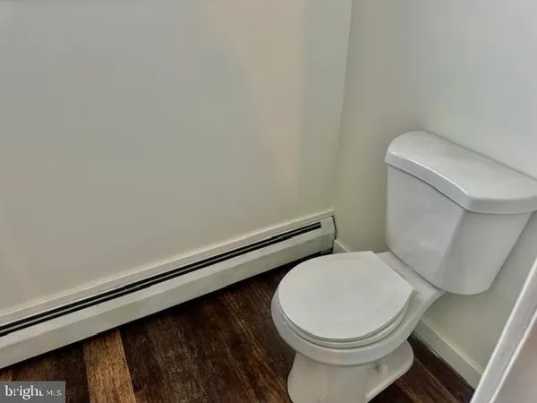 a white toilet sitting next to a white sink