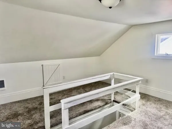 a view of room with wooden floor