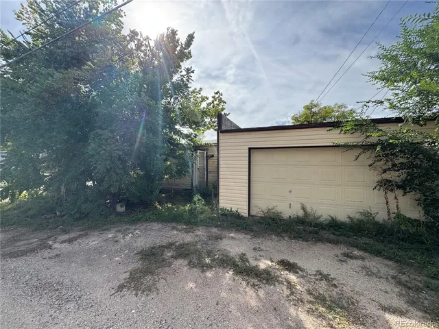 a backyard of a house with plants and trees